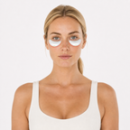 White wireless red light eye device held next to a model's face